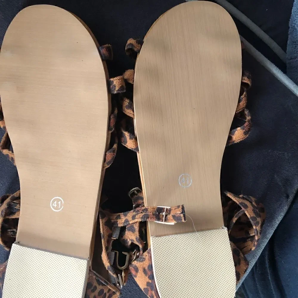 New never worn animal print buckle sandals. Side clasps . Zipper up the back.